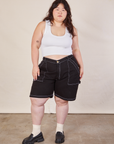 Ashley is 5'7" and wearing 1XL Carpenter Shorts in Basic Black paired with a Cropped Tank in vintage tee off-white