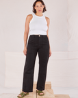 Tiara is 5'4" and wearing S Organic Work Pants in Basic Black paired with a Racerback Tank in vintage tee off-white