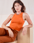 Alex is wearing Racerback Tank in Sunset Orange