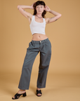 Alex is 5'8" and wearing XXS Baggy Mid-Rise Trousers in Slate Grey paired with a vintage tee white Cropped Tank