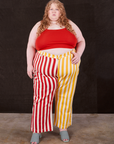 Catie is 5'10" and wearing 5XL Western Pants in Ketchup/Mustard Stripes paired with mustang red Cami