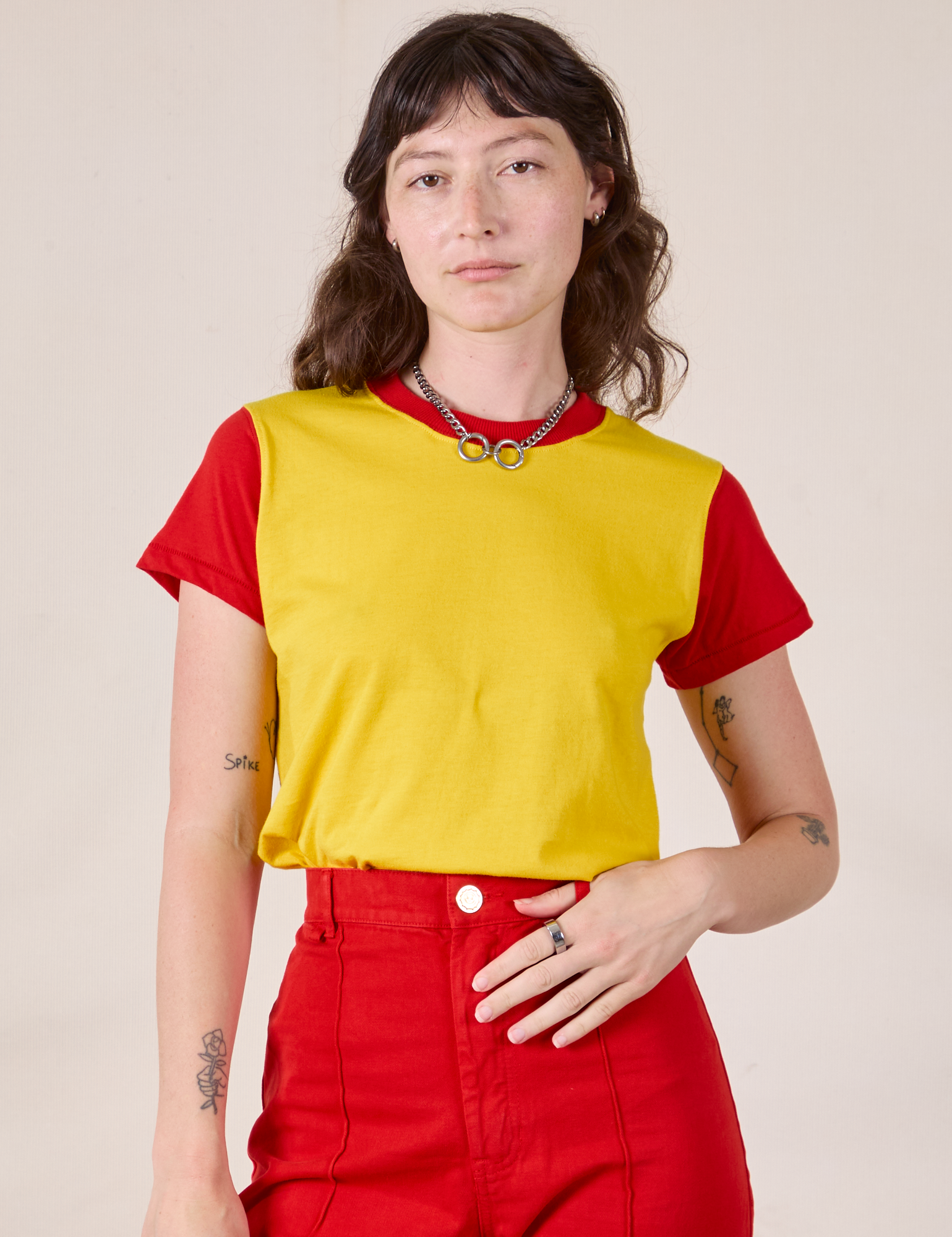 Alex is 5’8” and wearing P Mismatched Tee in Yellow & Red