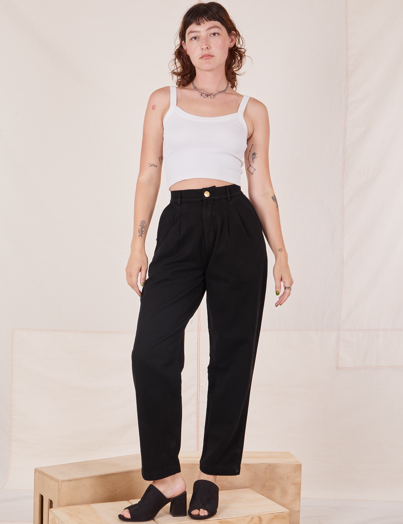 Alex is wearing Organic Trousers in Basic Black and Cropped Cami in vintage tee off-white