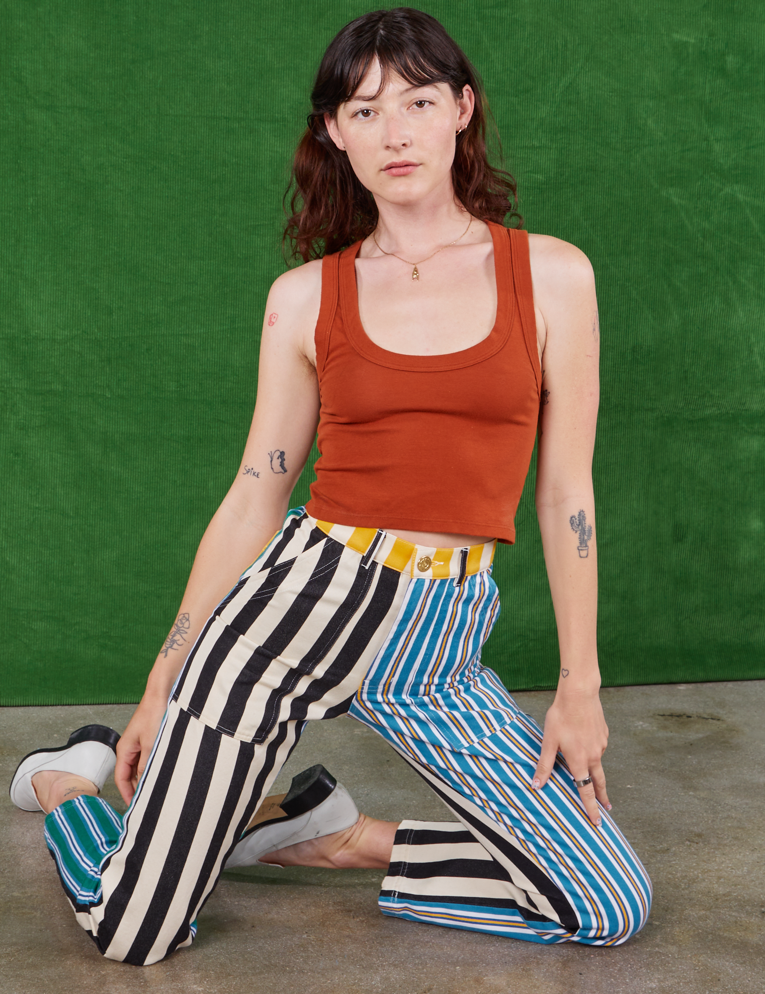 Alex is wearing Mismatched Stripe Work Pants and burnt terracotta Cropped Tank Top