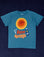 Palm Springs Tourist Tee with sun block lotion and illustrated smiling sun. Printed on a marine blue tee.