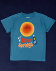 Palm Springs Tourist Tee with sun block lotion and illustrated smiling sun. Printed on a marine blue tee.