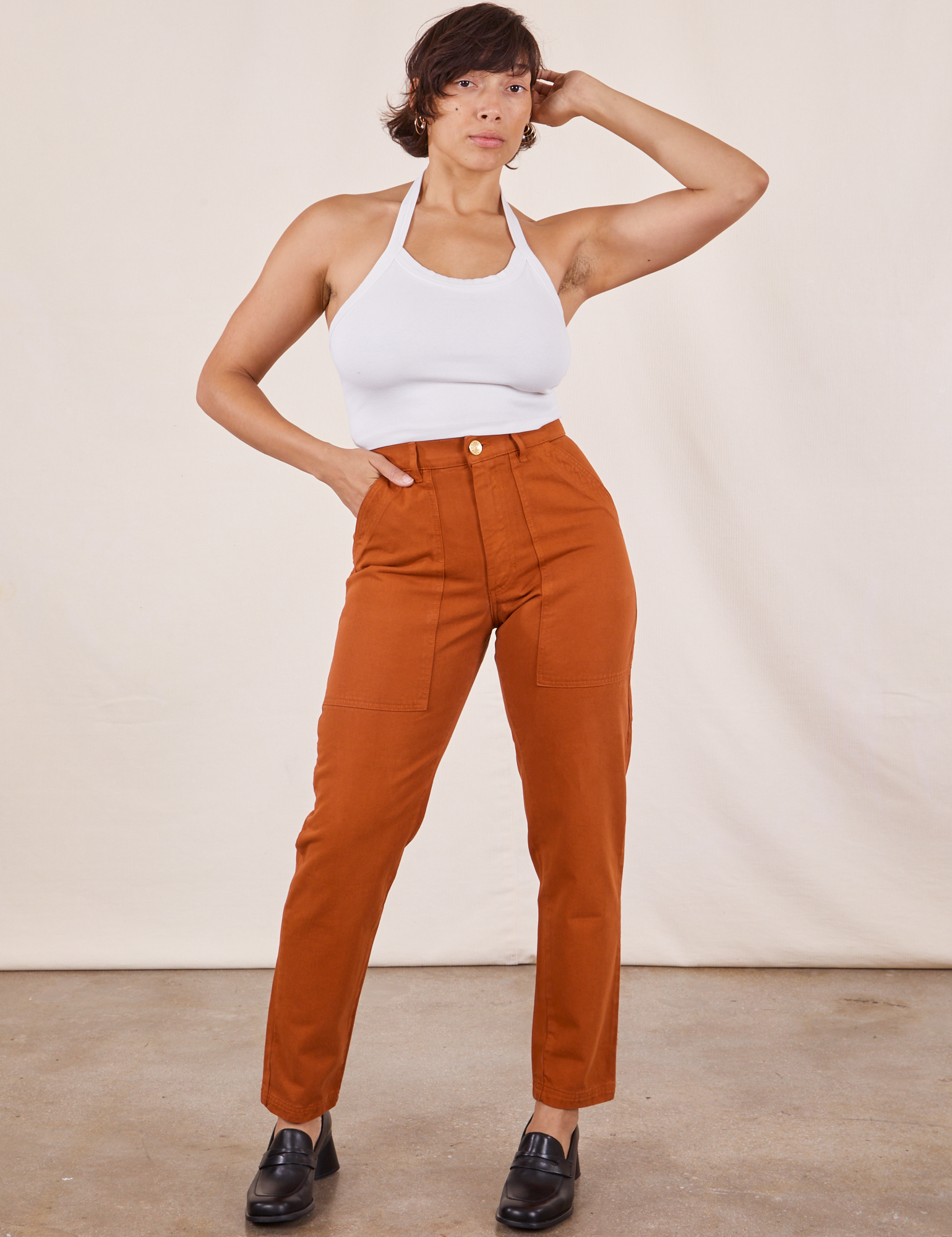 Tiara is 5'4" and wearing XS Pencil Pants in Burnt Terracotta paired with Halter Top in vintage tee off-white