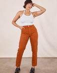 Tiara is 5'4" and wearing XS Pencil Pants in Burnt Terracotta paired with Halter Top in vintage tee off-white