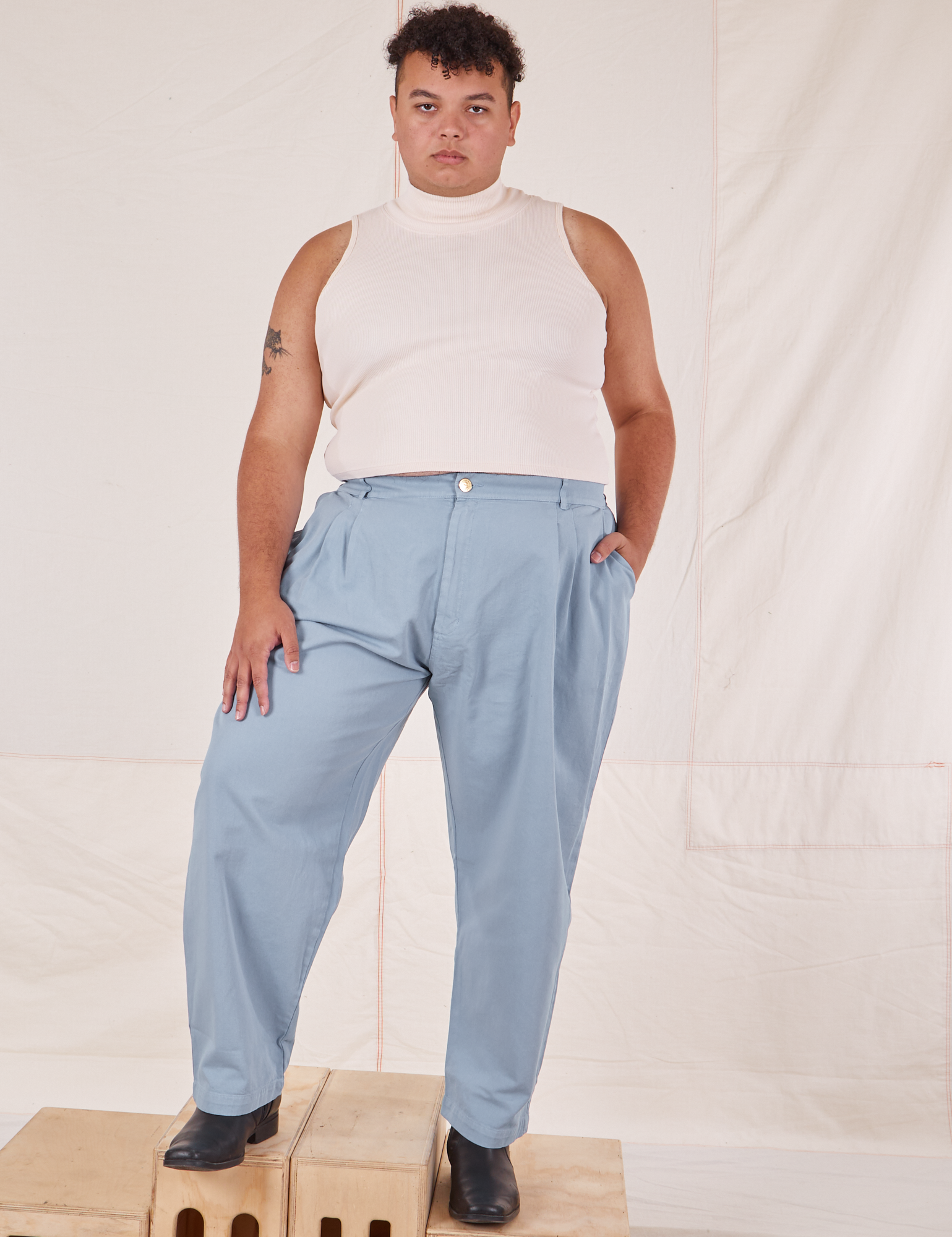 Miguel is 6&#39;0&quot; and wearing 1XL Heavyweight Trousers in Periwinkle paired with vintage off-white Sleeveless Turtleneck
