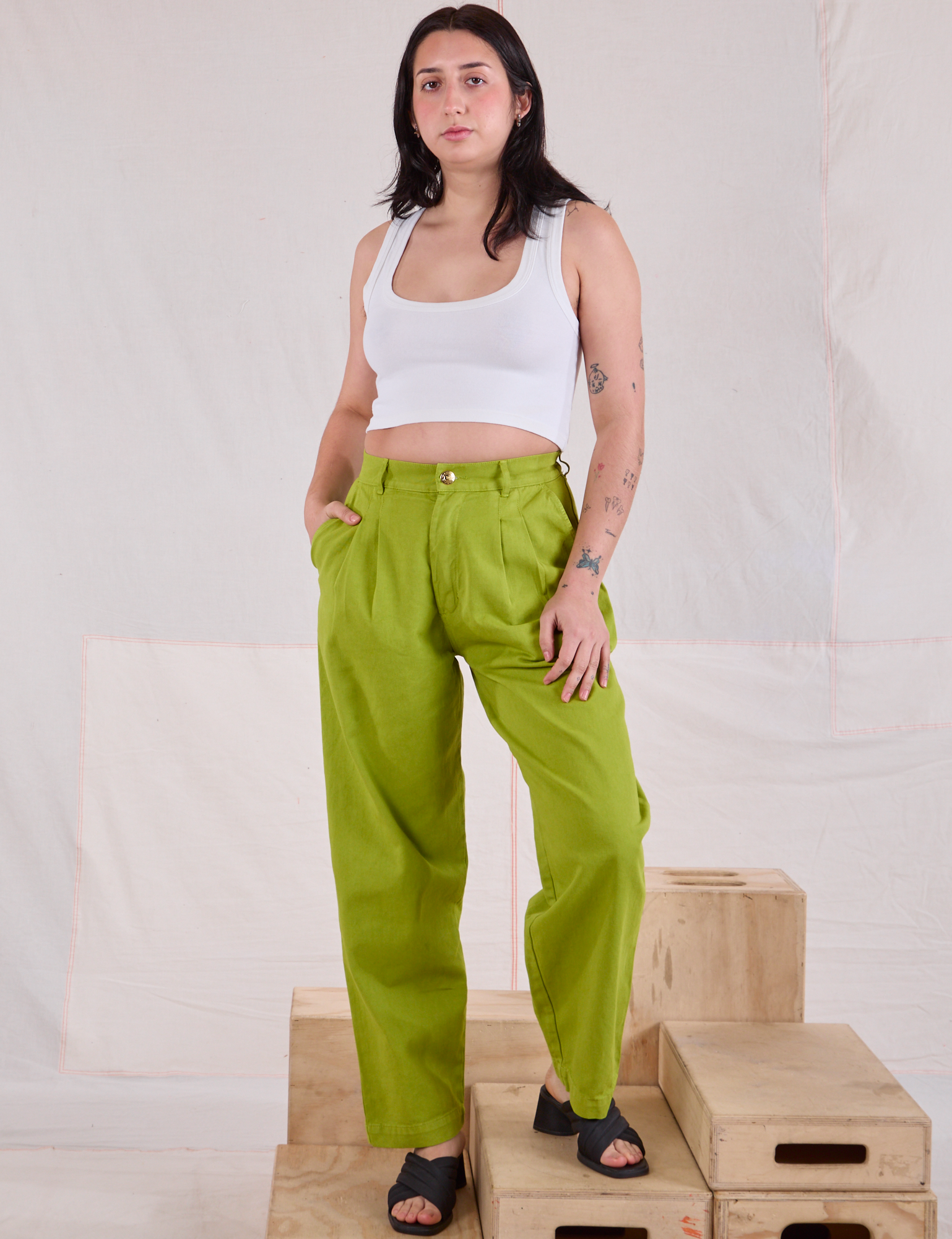 Betty is 5'8" and wearing XXS Heavyweight Trousers in Gross Green paired with a Cropped Tank in vintage tee off-white