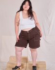 Ashley is 5'7" and wearing 1XL Railroad Carpenter Shorts in Fudgesicle Brown paired with a Cropped Tank in Vintage Tee Off-White