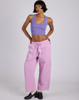 Kira is 5’10” and wearing XS Drop Pocket Cargo Pants in Lilac Purple paired with faded grape Cropped Tank