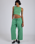 Kira is 5’10” and wearing XS Drop Pocket Cargo Pants in Seafoam Green paired with matching muscle tee