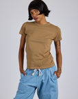 Kira is 5’10” and wearing P Jr. Varsity Tee in Desert Brown