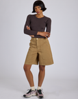 Kira is 5’10” and wearing XS Longline Work Shorts in Desert Brown paired with espresso Long Sleeve Baby Tee