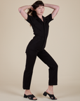 Alex is 5'8" and wearing XS Short Sleeve Jumpsuit in Basic Black