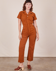 Alex is 5'8" and wearing XS Short Sleeve Jumpsuit in Burnt Terracotta