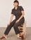 Tiara is wearing Short Sleeve Jumpsuit in Espresso Brown