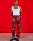 Jerrod is 6'3" and wearing M Paintstamped Work Pants in Cherry paired with a Cropped Tank in vintage tee off-white