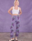Madeline is 5'9" and wearing XXS Paintstamped Work Pants in Grape paired with a Cropped Tank in Vintage Tee Off-White