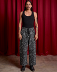 Anthony is 5'6" and wearing S Drop Pocket Cargo Pants in Spider Webs paired with a black Cropped Tank