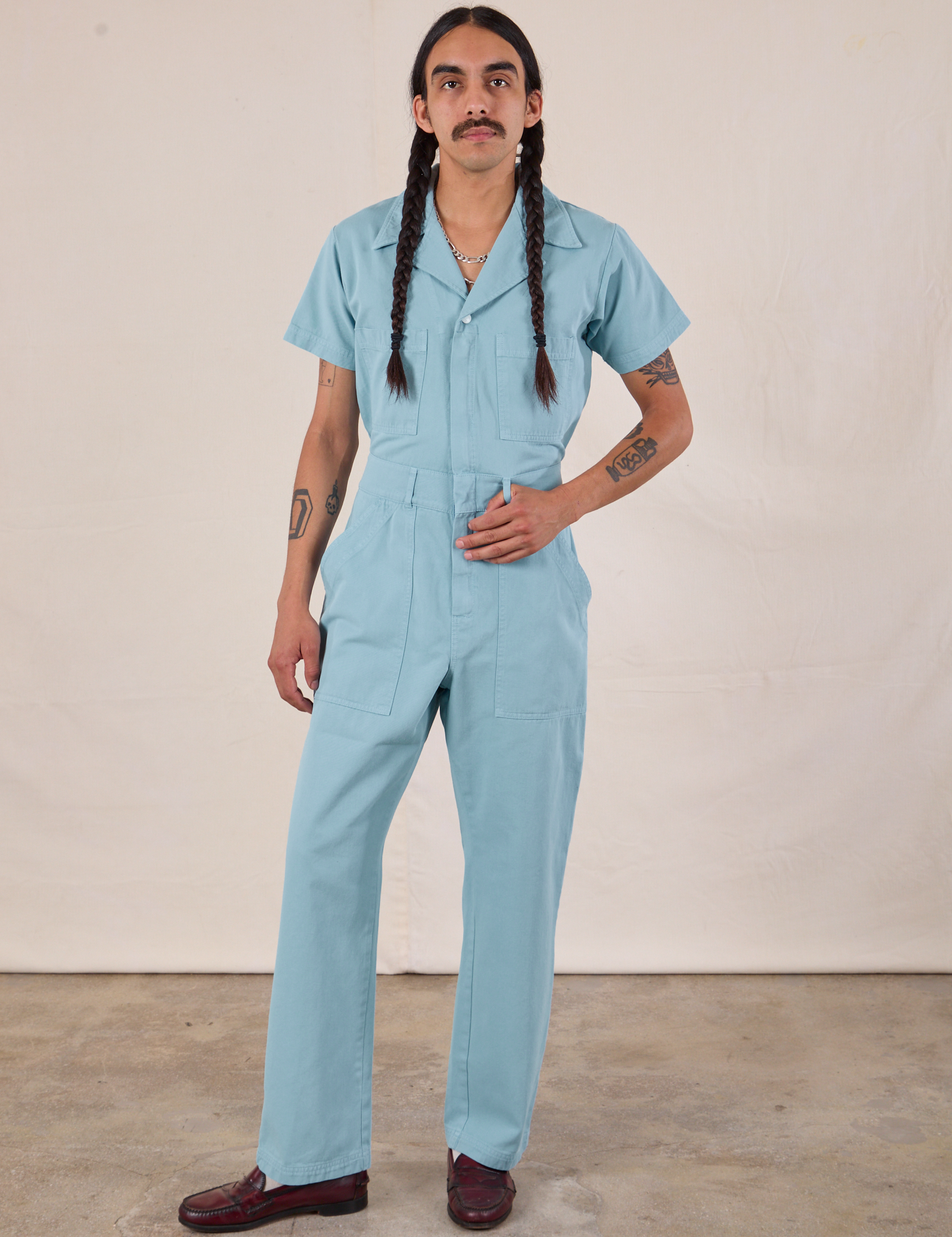 Anthony is 5'10" and wearing S Short Sleeve Jumpsuit in Baby Blue