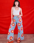 Alex is 5'8" and wearing XXS Wide Leg Denim Trousers in Painted Flowers paired with a Cropped Tank in Vintage Tee Off-White