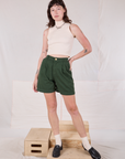 Alex is 5’8” and wearing XXS Trouser Shorts in Swamp Green paired with a vintage tee off-white Sleeveless Turtleneck