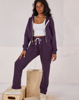 Kandia is 5'3" and wearing P Rolled Cuff Sweat Pants in Nebula Purple paired with matching Cropped Zip Hoodie and a Cropped Tank in vintage tee off-white underneath