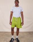 Isaac is 5'10" and wearing M Sweat Shorts in Gross Green paired with a stone white Jr. Varsity Tee