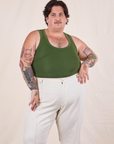 Sam is wearing XL Tank Top in Dark Emerald Green paired with vintage tee off-white Western Pants