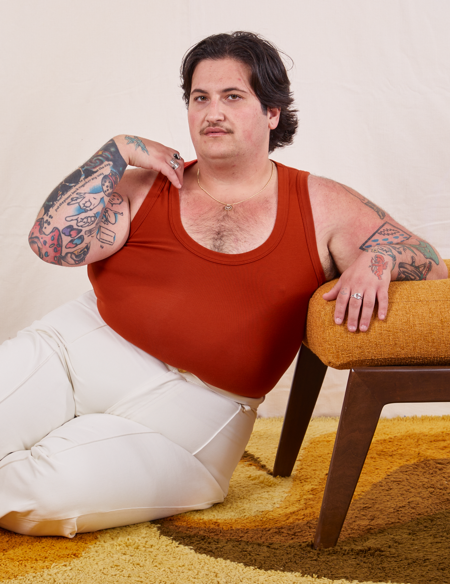 Sam is wearing size XL Tank Top in Paprika paired with vintage tee off-white Western Pants