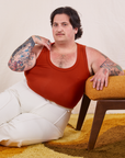 Sam is wearing size XL Tank Top in Paprika paired with vintage tee off-white Western Pants