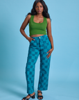 Kandia is 5'3" and wearing XS Checkerboard Work Pants in Blues paired with lawn green Cropped Tank