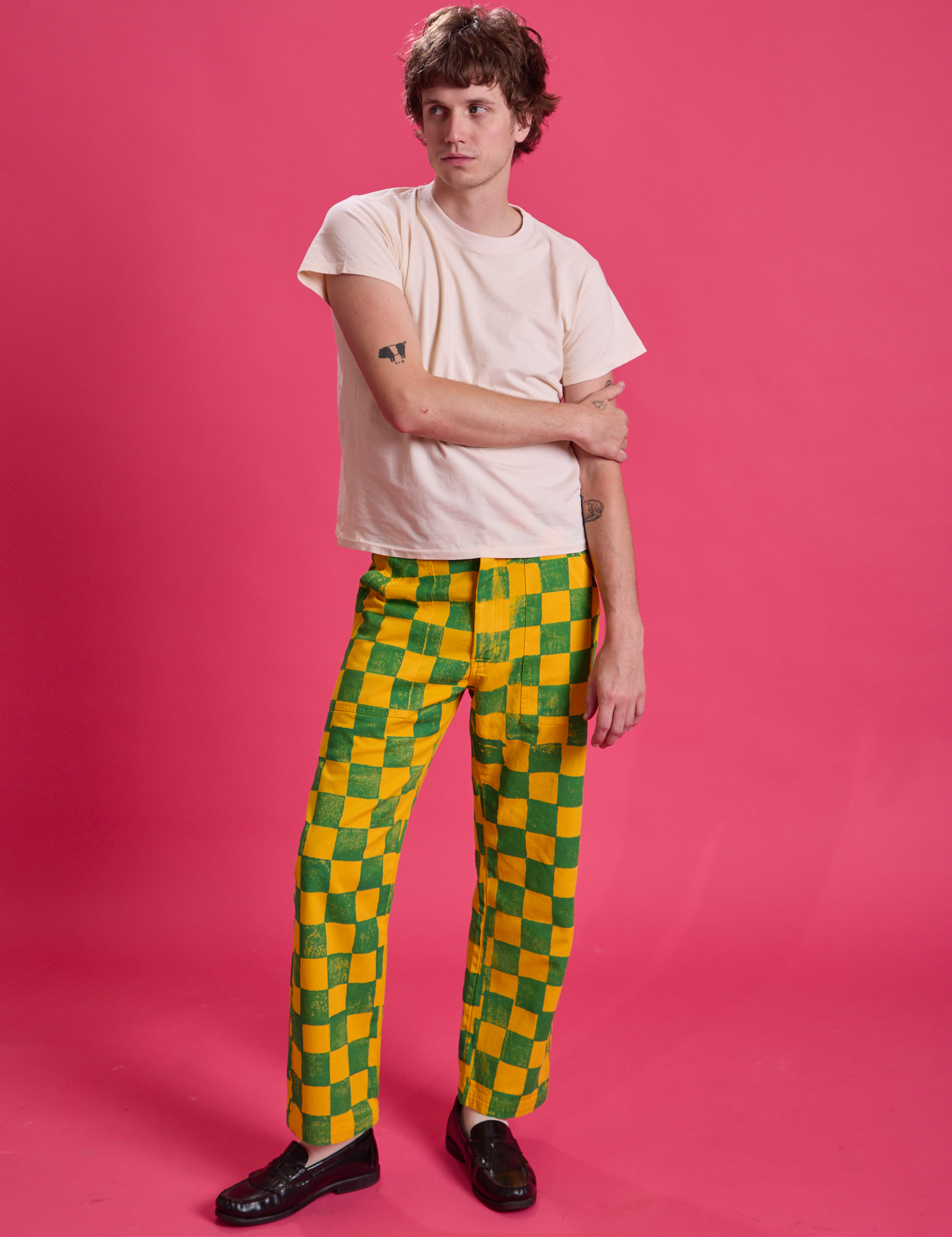 Quinn is 6'3" and wearing M Checkerboard Work Pants in Green/Yellow paired with an Organic Vintage Tee in Vintage Off-White