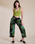 Alex is 5’8” and wearing XXS Magic Waters Drop Pocket Pants in Green Pool paired with gross green Cropped Tank