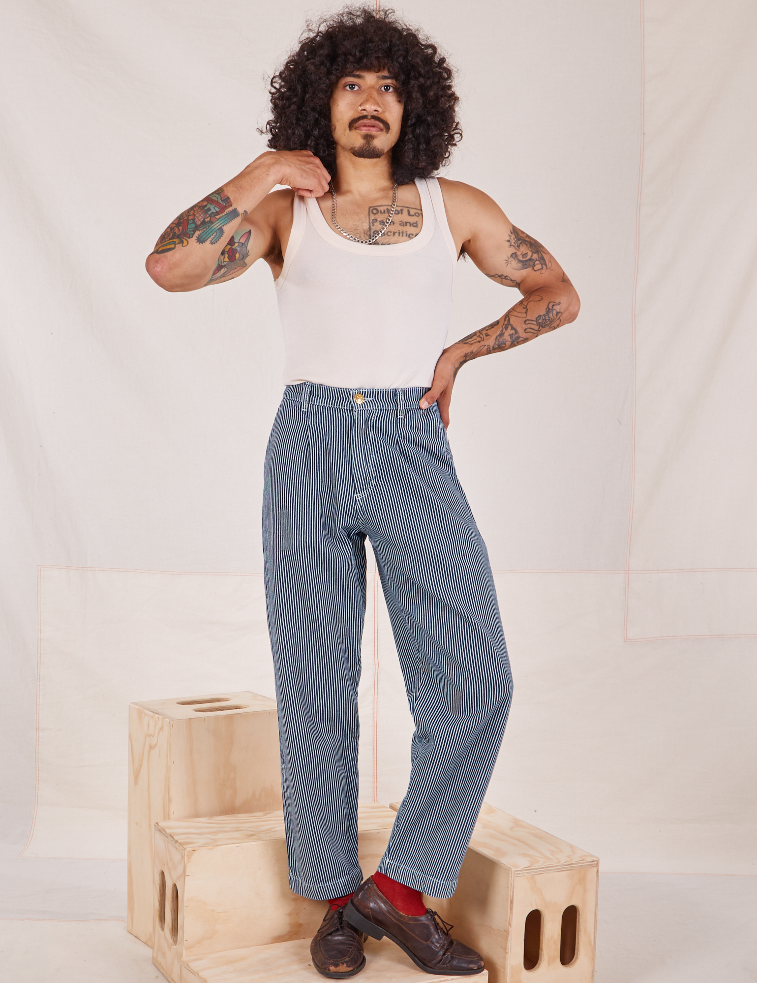 Jesse is 5&#39;8&quot; and wearing XXS Denim Trouser Jeans in Railroad Stripe paired with a vintage off-white Tank Top