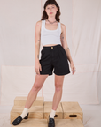 Alex is 5’8” and wearing XXS Trouser Shorts in Basic Black paired with a Cropped Tank in vintage tee off-white
