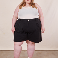 Catie is 5'11" and wearing 4XL Trouser Shorts in Basic Black paired with a vintage off-white Tank Top
