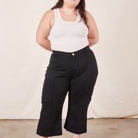 Ashley is 5'7 and wearing 1XL Petite Western Pants in Basic Black paired with vintage off-white Tank Top