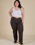 Ashley is 5’7” and wearing 1XL Work Pants in Espresso Brown paired with a vintage tee white Cropped Tank