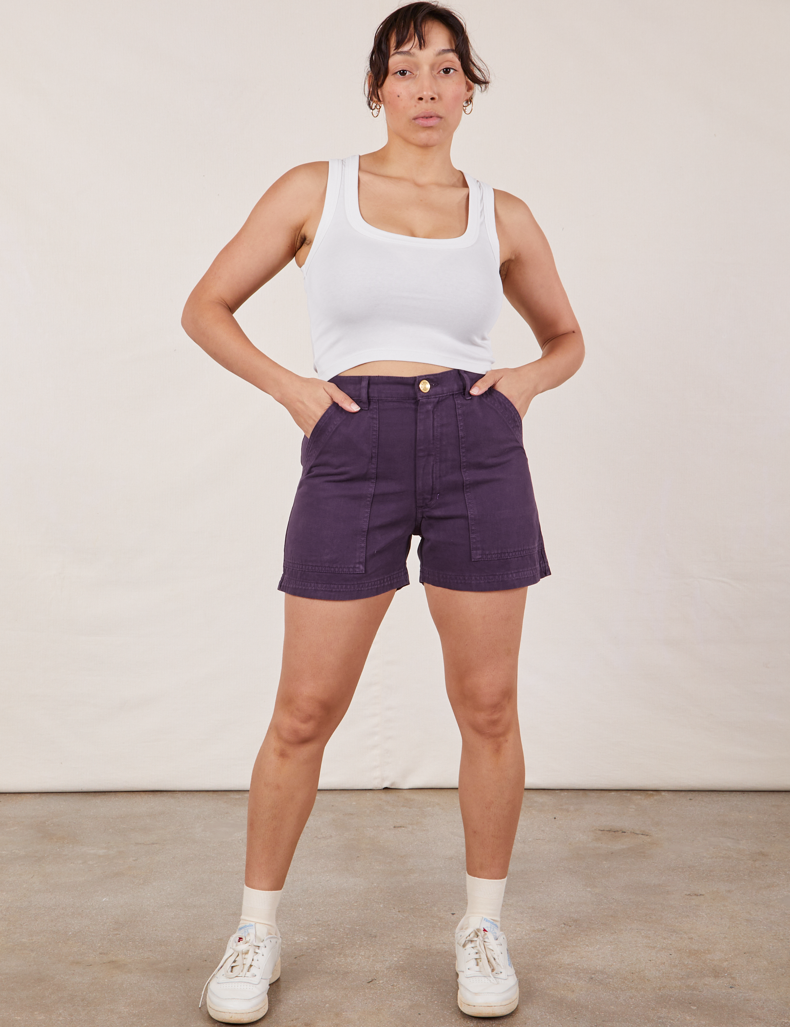 Tiara is 5’4” and wearing S Classic Work Shorts in Nebula Purple paired with Cropped Tank Top in vintage tee off-white