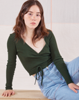Hana is 5'3" and wearing size 1 Wrap Top in Swamp Green