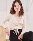 Hana is 5'3" and wearing size 1 Wrap Top in Vintage Tee Off-White