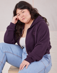 Ashley is wearing Cropped Zip Hoodie in Nebula Purple and light wash Carpenter Jeans