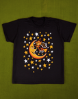 Vintage Tee in Moon & Witch. Black tee body with yellow and white stars surrounding a moon and witch