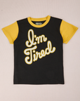 Anniversary Tee in I’m Tired. Black t-shirt body with yellow sleeves and neckline. I'm Tired graphic in white type with yellow border.