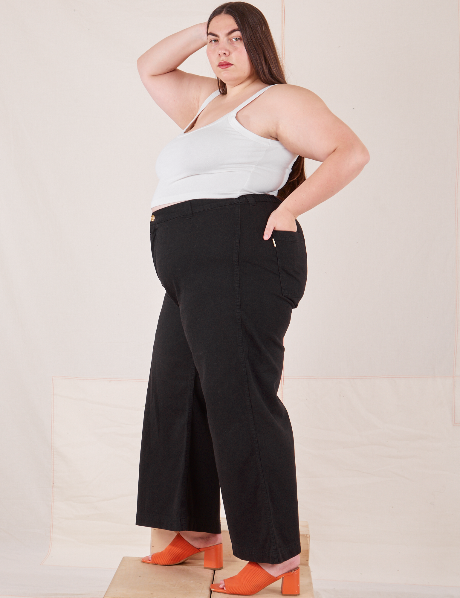 Side view of Bell Bottoms in Basic Black and Cropped Cami in vintage tee off-white on Marielena