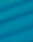 Calypso Tee in Rainbow fabric detail close up. Hawaiian blue tee body.