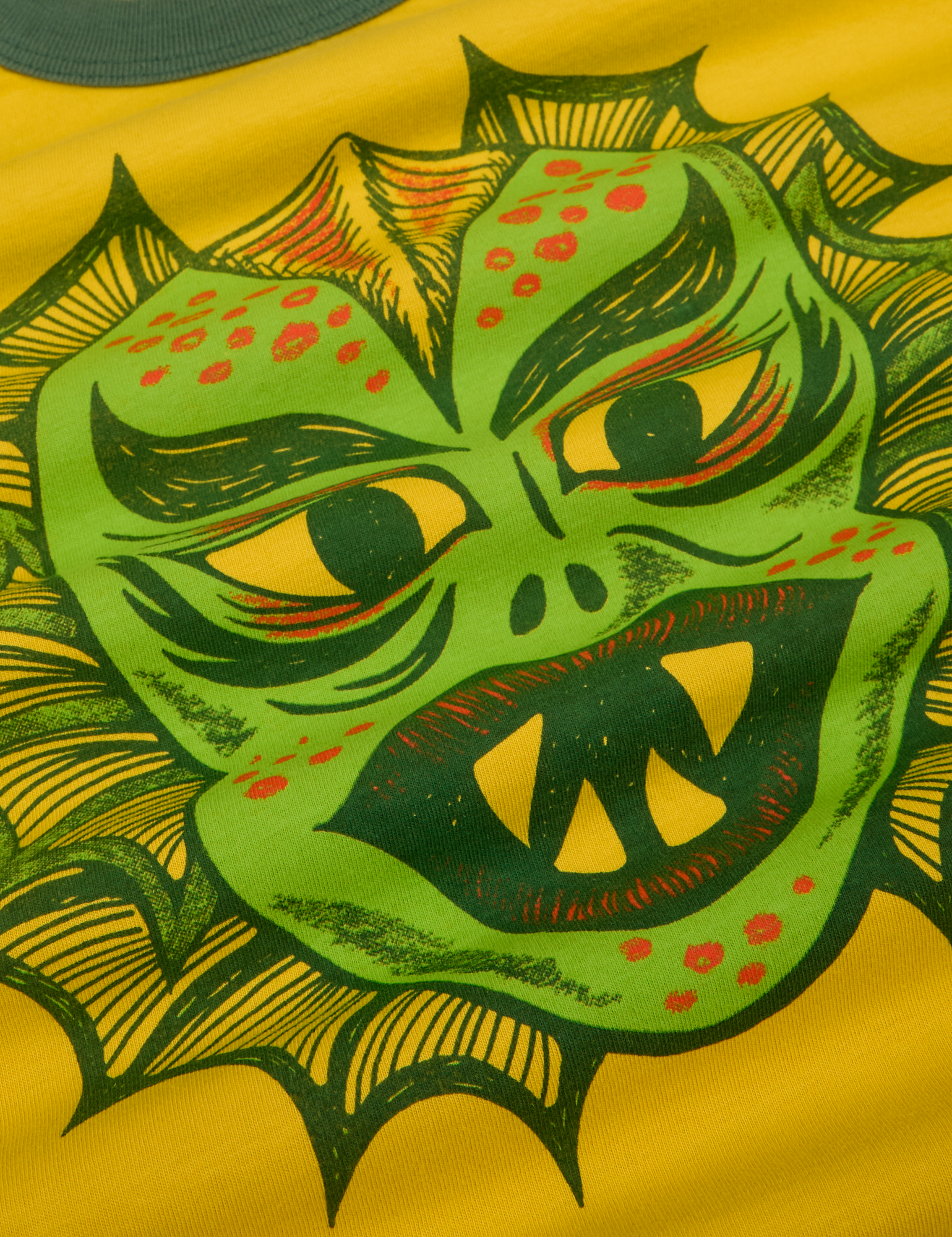 Close up of screenprinted creature on front of shirt